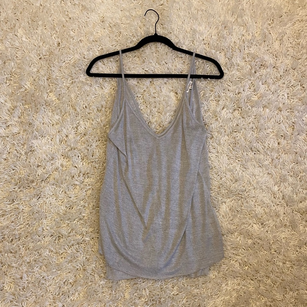 Deep cut, long, gray tank top with small slit on sides